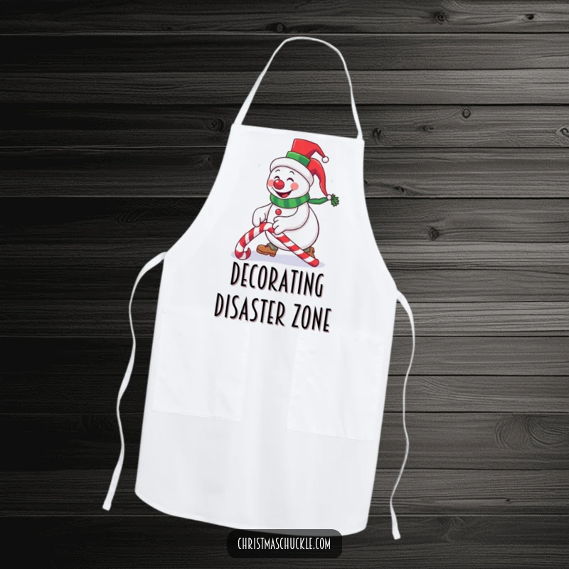 Funny snowman clown wearing a tiny top hat, tripping over a candy cane, humorous apron for cooking and baking during holidays.