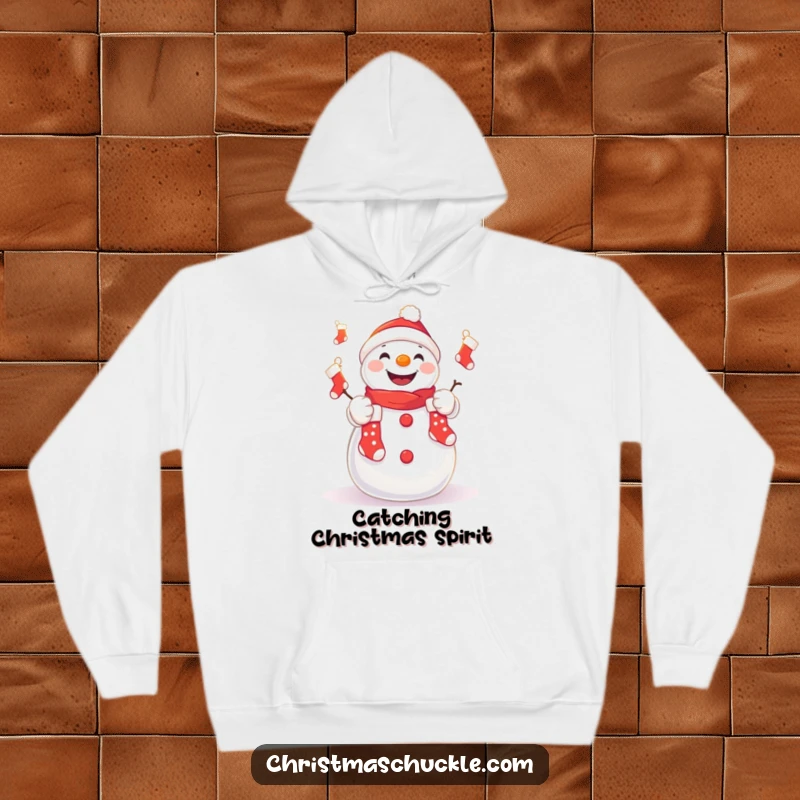Funny hoodie with a cute kawaii snowman juggling tiny Christmas stockings, comfortable and humorous winter wear.