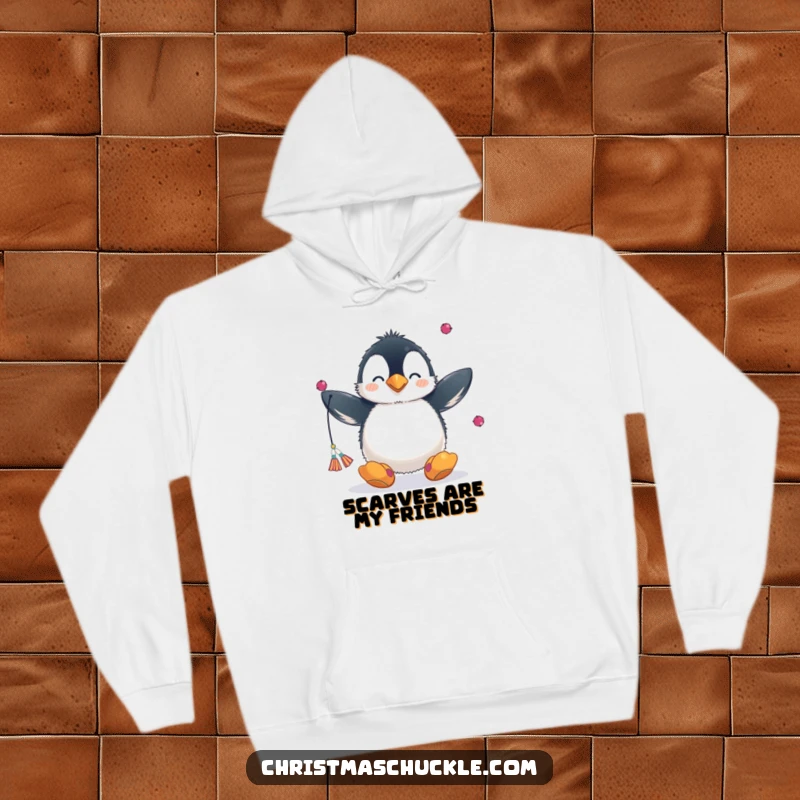 Funny hoodie with a fluffy penguin wearing a clown nose and big shoes, juggling scarves, embodying playful winter fun.