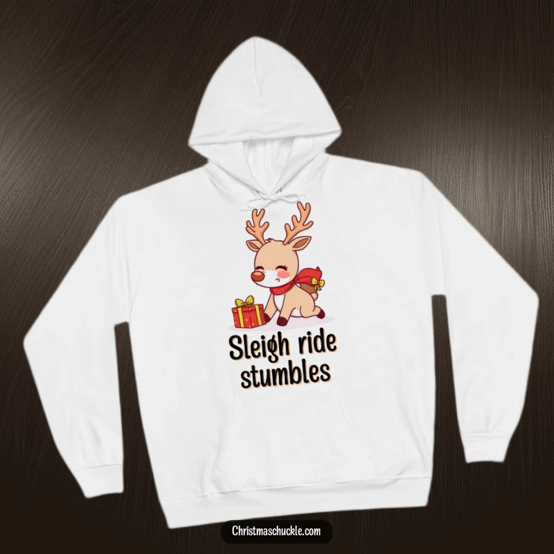 Funny blushing reindeer tripping while delivering a gift on a cozy hoodie, perfect for warm holiday mishaps.