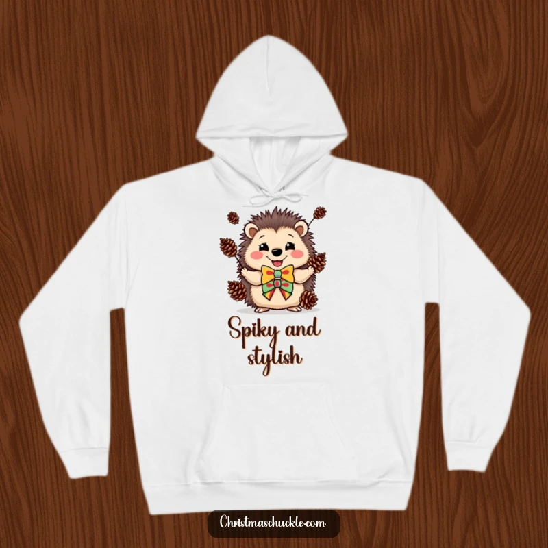 Funny hoodie showing a happy hedgehog in a clown bowtie, juggling pinecones, perfect for cozy fun.