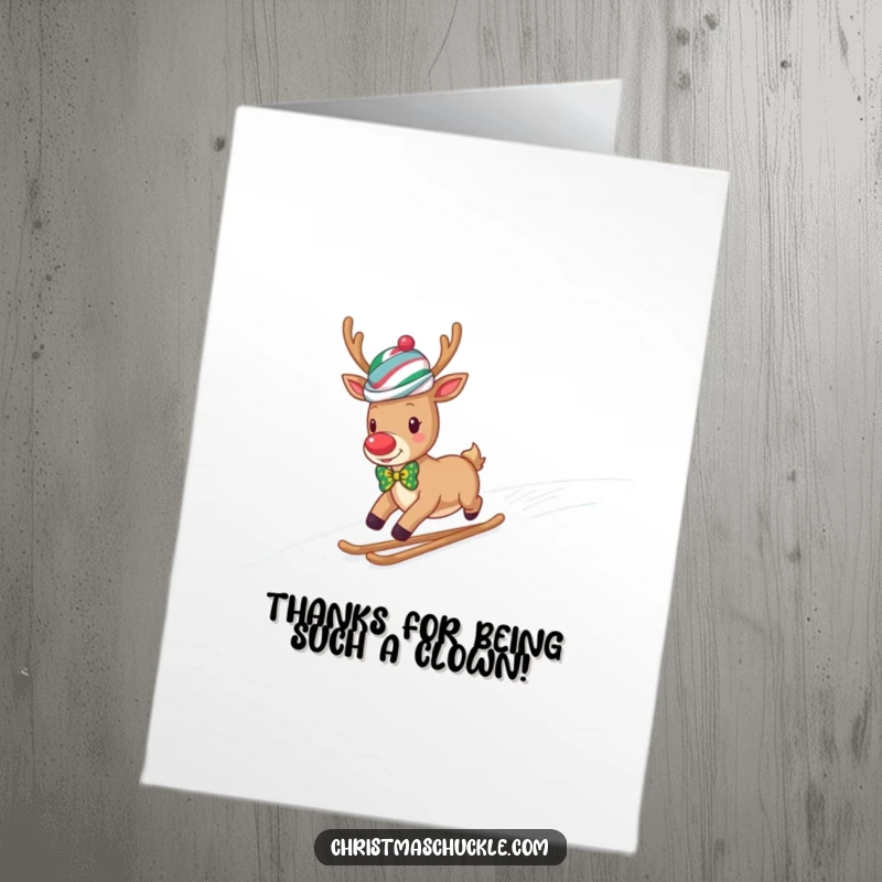 Funny Free Printable thank you card of a reindeer in a clown wig and bow tie sliding down a snowy hill.