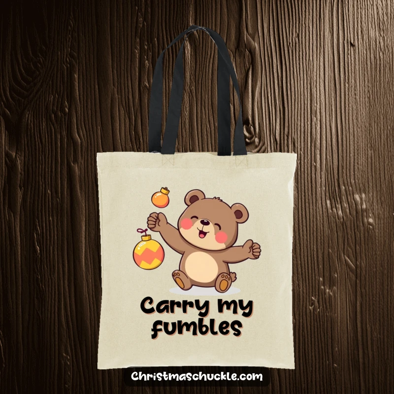 Funny tote bag featuring a happy bear character clumsily juggling three brightly colored ornaments, perfect for holiday shopping.